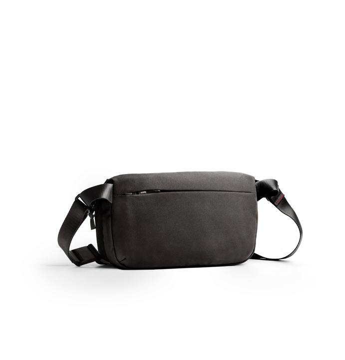 Midnight-black canvas crossbody bag with adjustable strap and zip closure