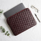 7Wallet 14-Inch Genuine Quilted Leather Laptop Sleeve in Burgundy with laptop being inserted from top