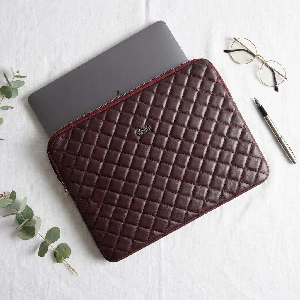 7Wallet 14-Inch Genuine Quilted Leather Laptop Sleeve in Burgundy with laptop being inserted from top