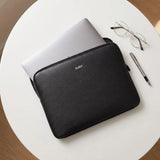 7Wallet 14-Inch Premium Epi Leather Laptop Sleeve in Black top-down view with laptop half inserted