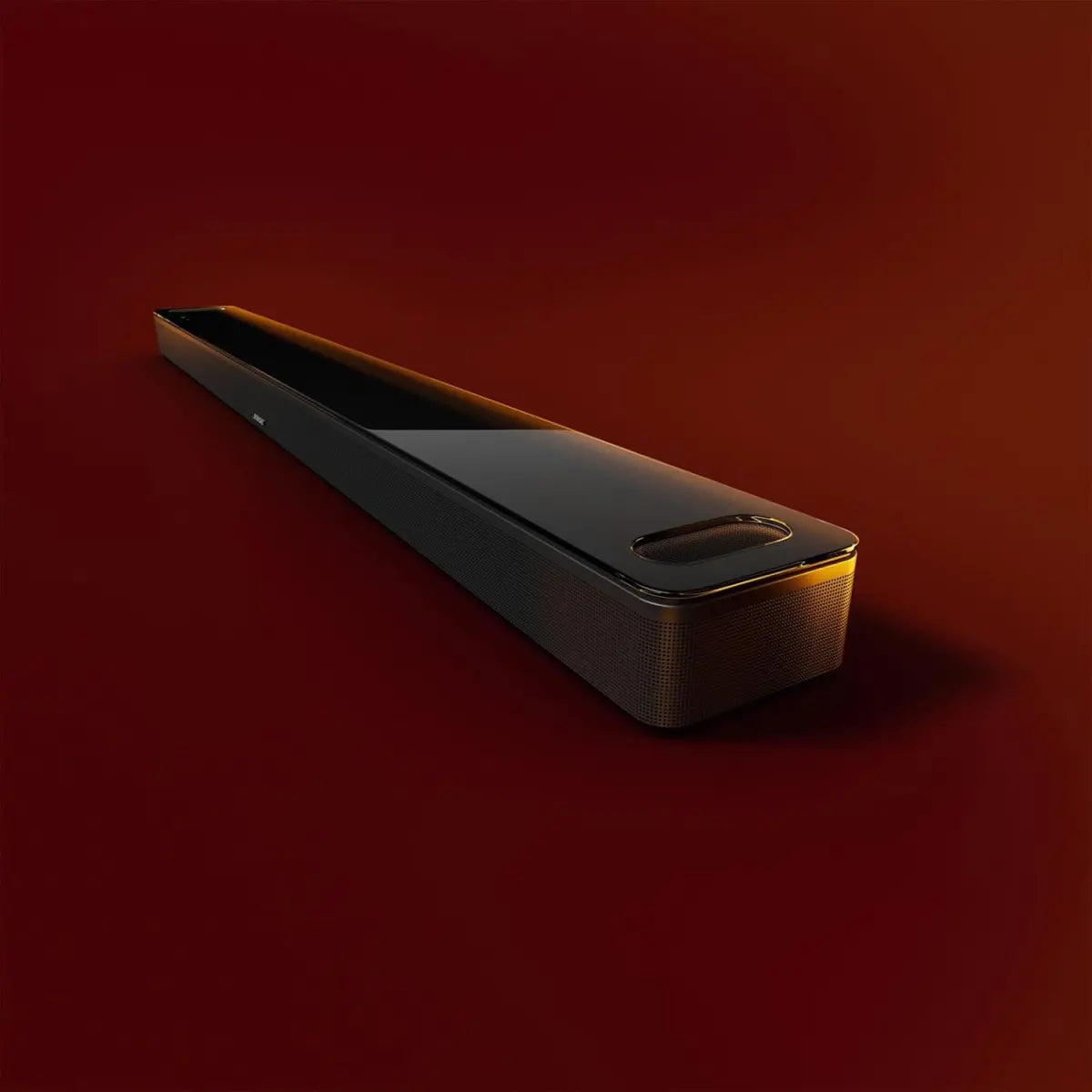 Bose Smart Ultra Soundbar premium design with glass top in warm lighting background