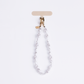 UNIQ COEHL PERLA UNIVERSAL PHONE CHARM HANDSTRAP - PEARL WHITE