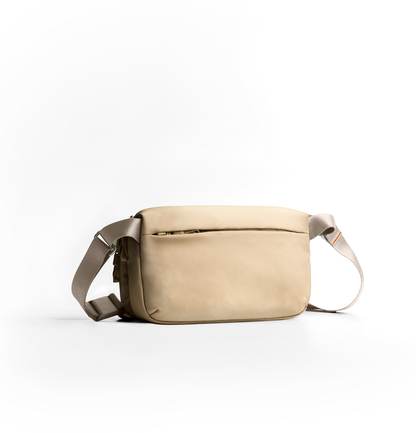 Desert-khaki canvas crossbody bag with adjustable strap and zip closure