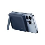 Dark blue slim power bank with built-in video stand holding a phone